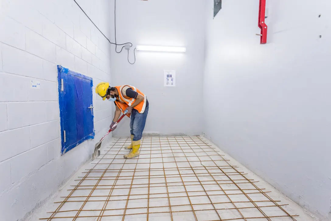 View of Ampang Park MRT Station Systems Room showing the painting works and floor screeding preparation.