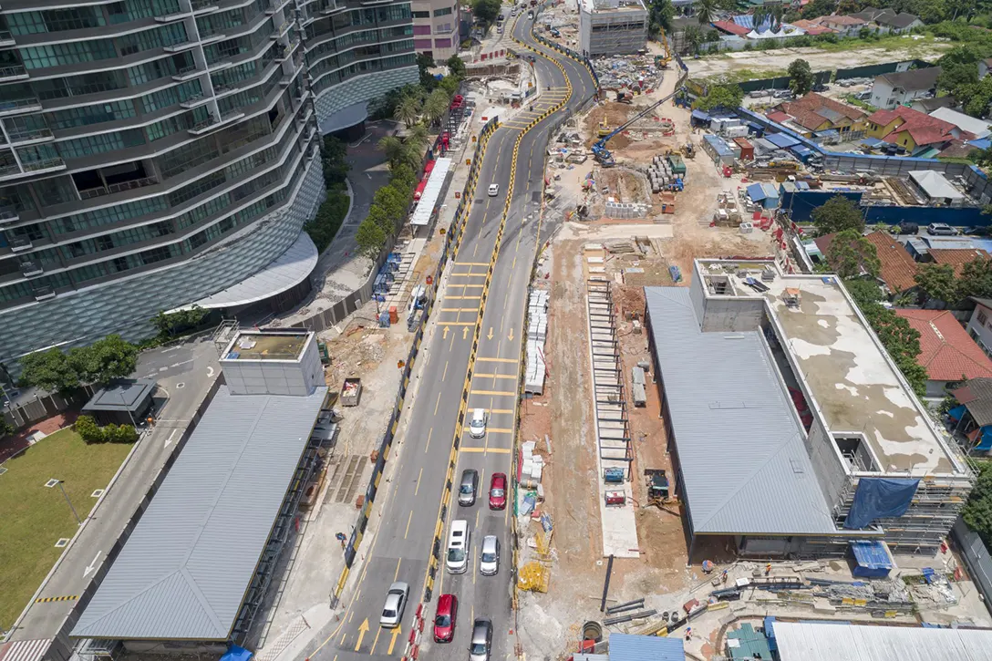 Aerial view of the completed Entrance A and B structures and remaining road as well as drainage works in progress at the Raja Uda MRT Station.