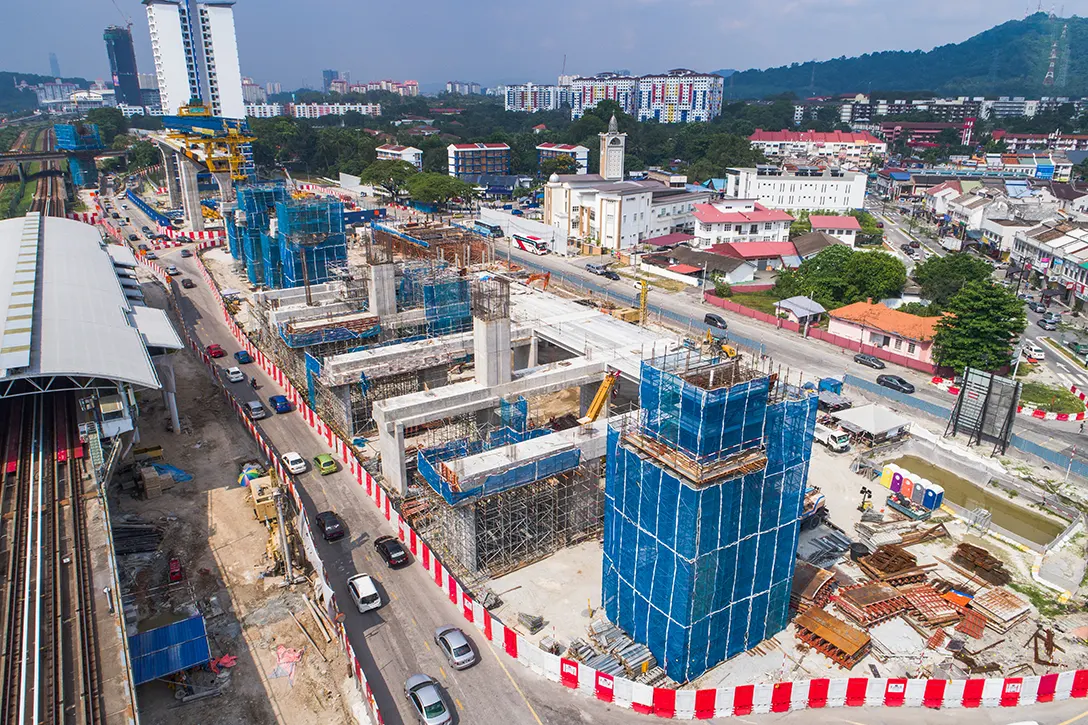 View of erection of segmental box girder and fixing rebar for concourse beam as well as pier head at the Sungai Besi MRT Station site. Also, can be seen is concreting works for pier head.