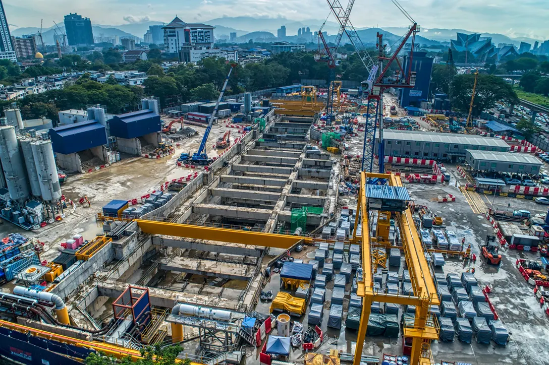 Aerial view of the Titiwangsa MRT Station site showing reinforced concrete structure and tunnelling works in progress.