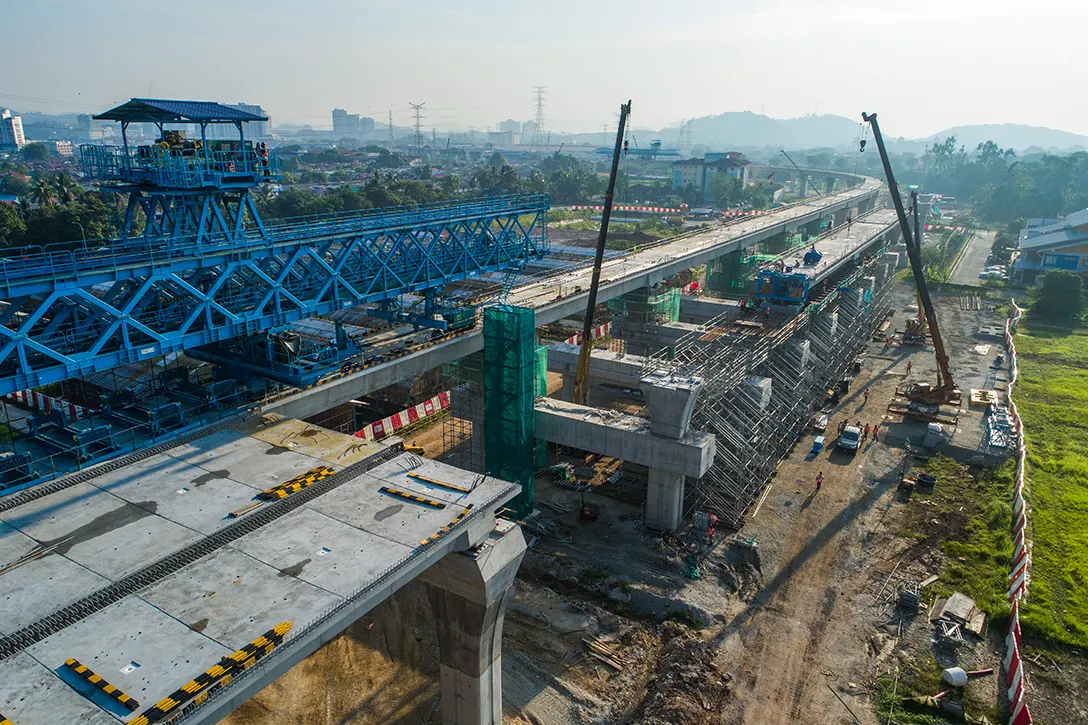 Aerial view of segmental box girder erection and installation works for parapet wall at the UPM MRT Station site.