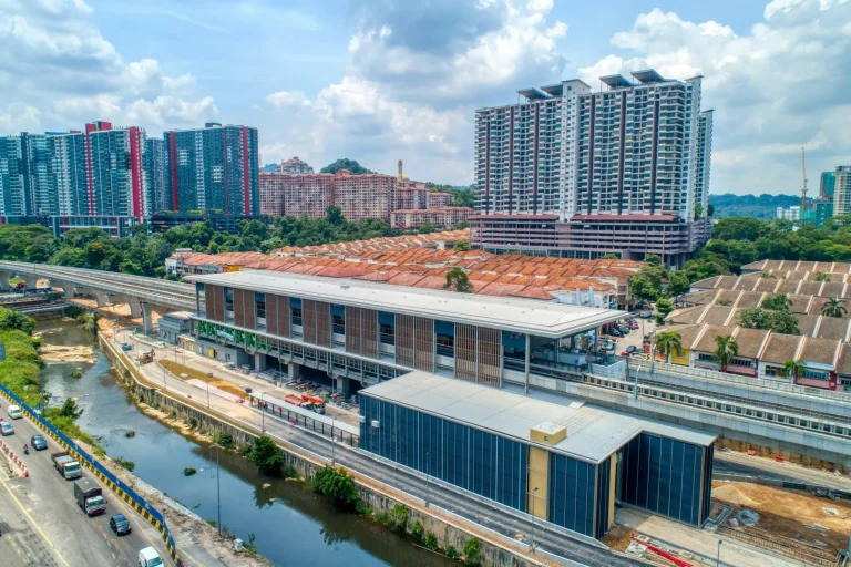 Aerial view of the Damansara Damai MRT Station showing the installation of mesh façade at entrances and roadwork in progress