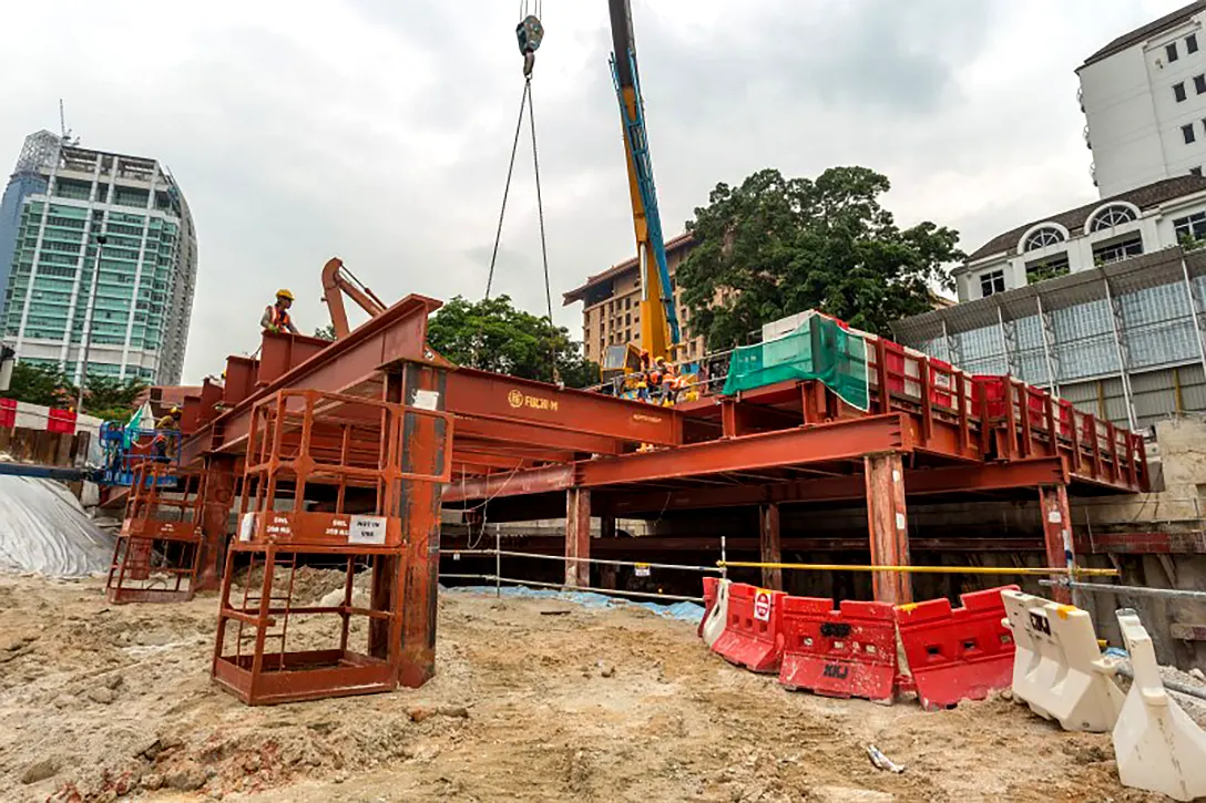 Installation work of construction decking at the Conlay MRT Station site.