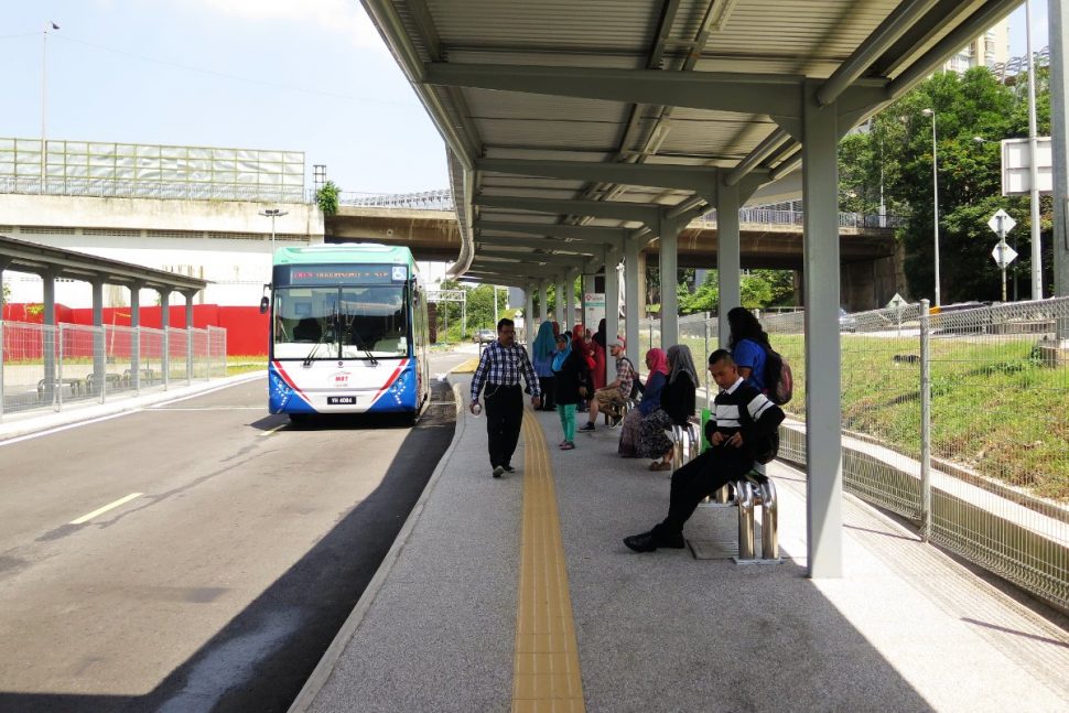 Commuters waiting for bus at the feeder bus hub.
