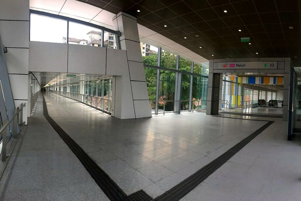 A covered walkway connects the two rail systems. The walk takes about 2 mins.