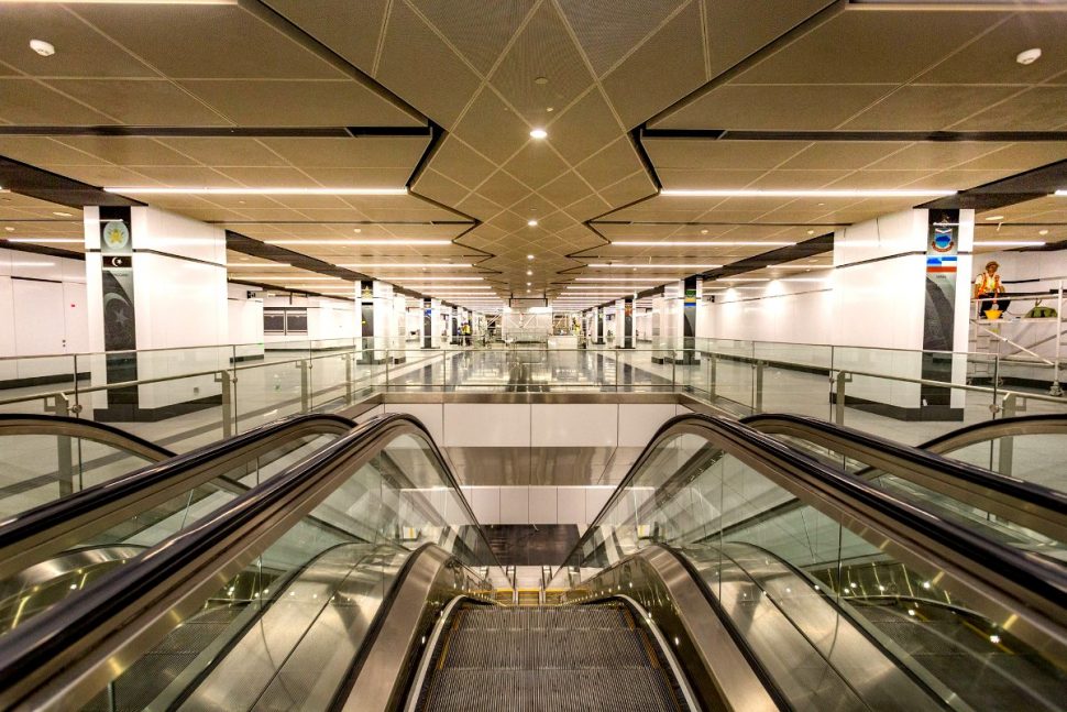 Escalator and stair access to train boarding platforms