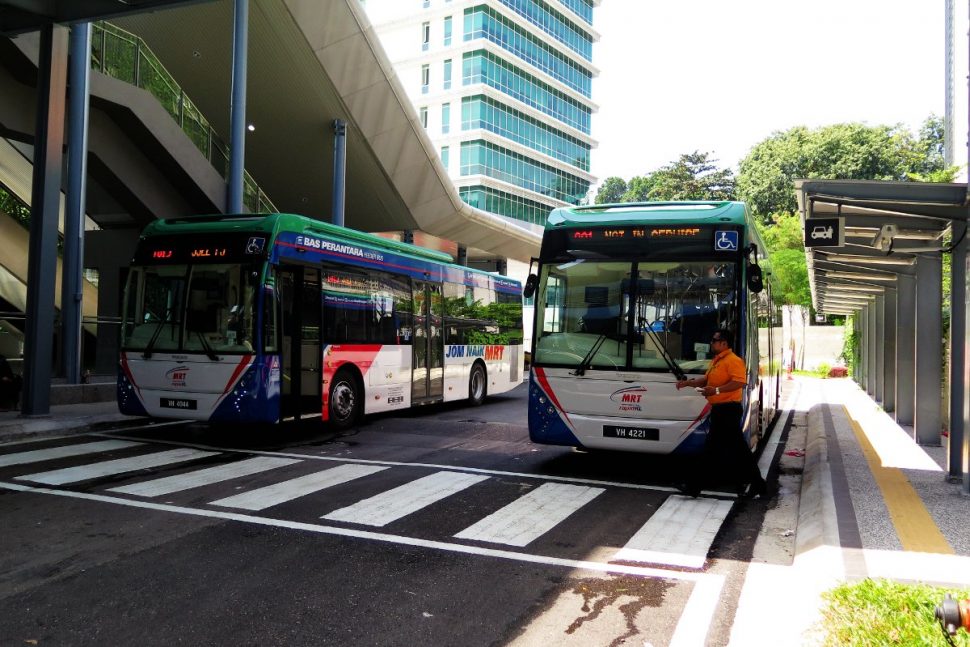 Shuttle buses waiting at bus stop near entrance A