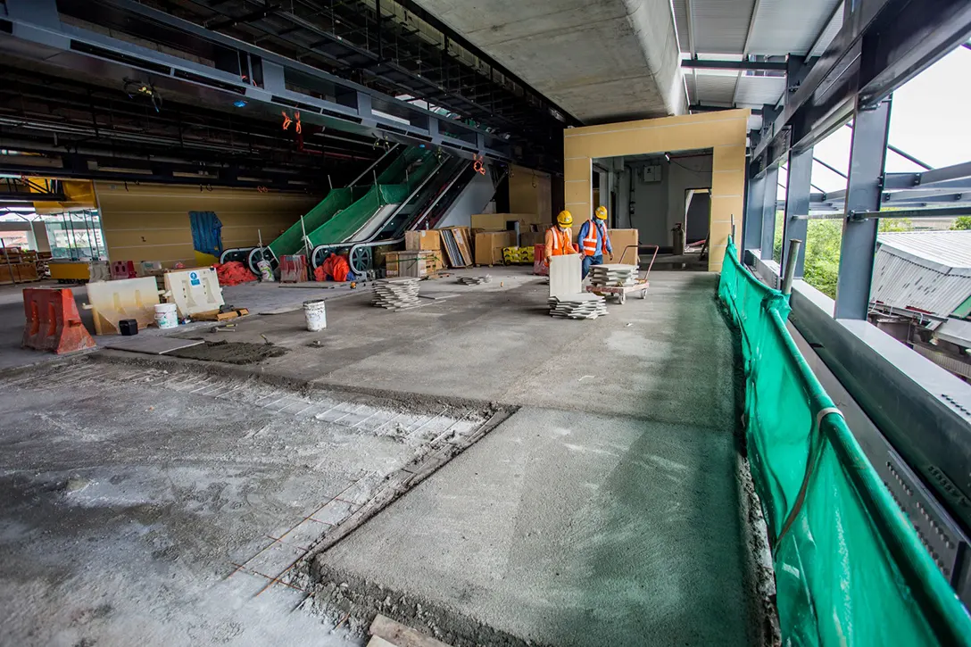 View inside the Putrajaya Sentral MRT Station showing floor screeding for tiling works at the station entrance.