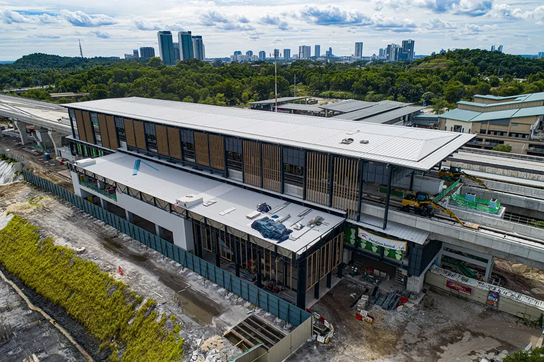 Aerial view of the Putrajaya Sentral MRT Station showing the façade at main station, mural painting works and tiling works at platform and concourse levels in progress