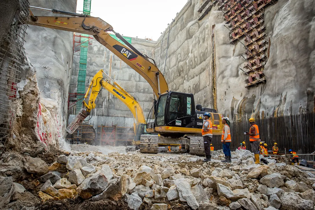 Ongoing trimming works for excavated rock surface using breaker at the Chan Sow Lin MRT Station site.