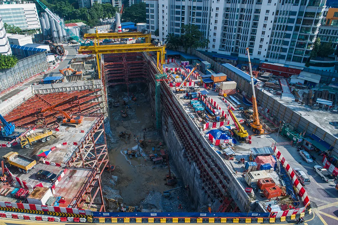 Top view of the Conlay MRT Station site showing soil mucking out and rebar installation activities in progress.