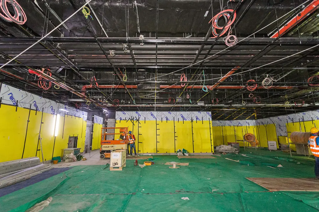 View inside the Conlay MRT Station showing the cladding works in progress at the concourse level.