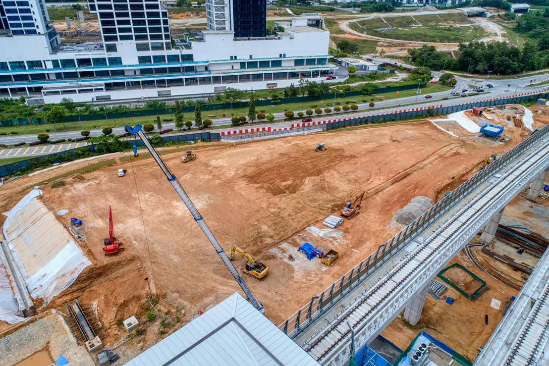 Aerial view of the Cyberjaya Utara MRT Station showing the at-grade park and ride platform preparation.