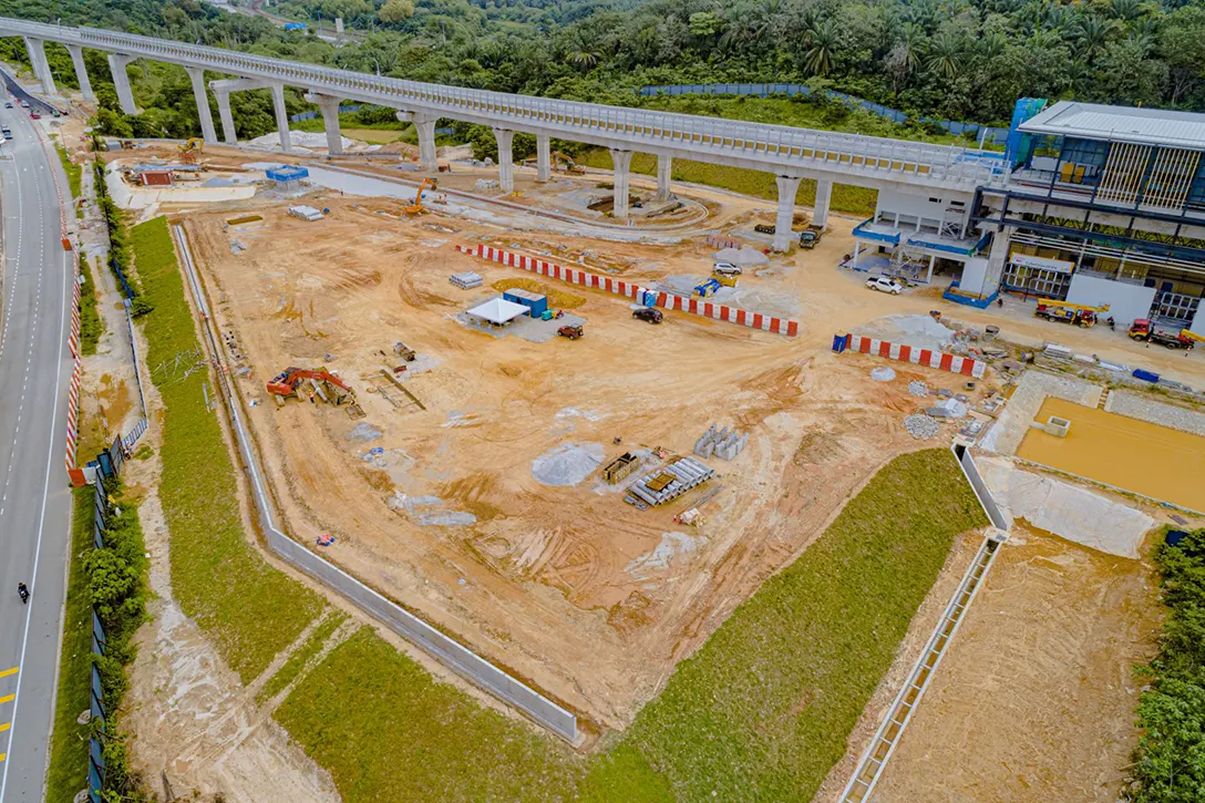 Aerial view of the Cyberjaya Utara MRT Station showing the at-grade park and ride ongoing works such as retaining wall and drainage works.