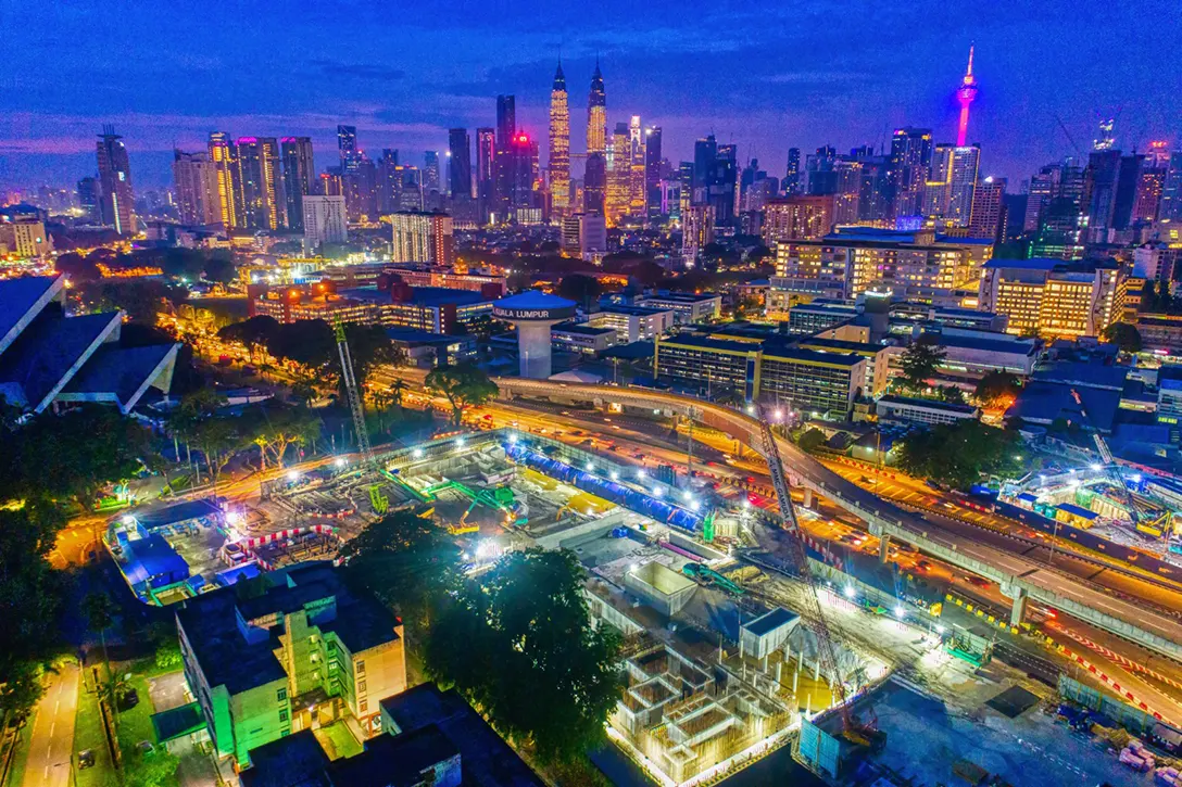 Night view of Hospital Kuala Lumpur MRT Station site showing reinforced concrete wall construction.