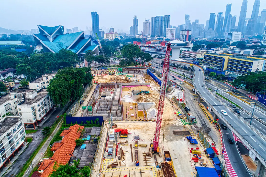 Aerial view of the Hospital Kuala Lumpur MRT Station site showing ongoing backfilling works above roof slab and removal of excavated soil from plantroom level.