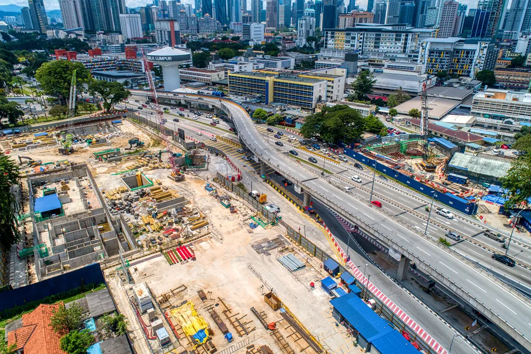 Aerial view of the Hospital Kuala Lumpur MRT Station site showing the ongoing reinforced concrete construction below ground and excavation works for Entrance B.
