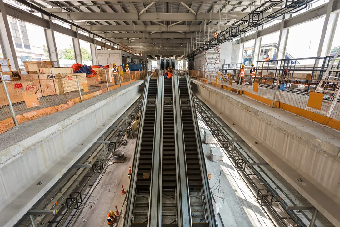 View of the Jalan Ipoh MRT Station showing the escalator railing glass installation in progress.