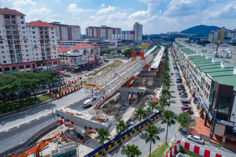 Aerial view of segmental box girder launching works of spans and permanent works for drainage at the Metro Prima MRT Station site