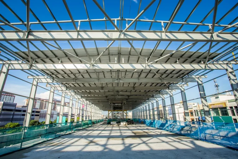 View inside the Metro Prima MRT Station showing the completed installation of steel structure frames and installation of roof covering in progress