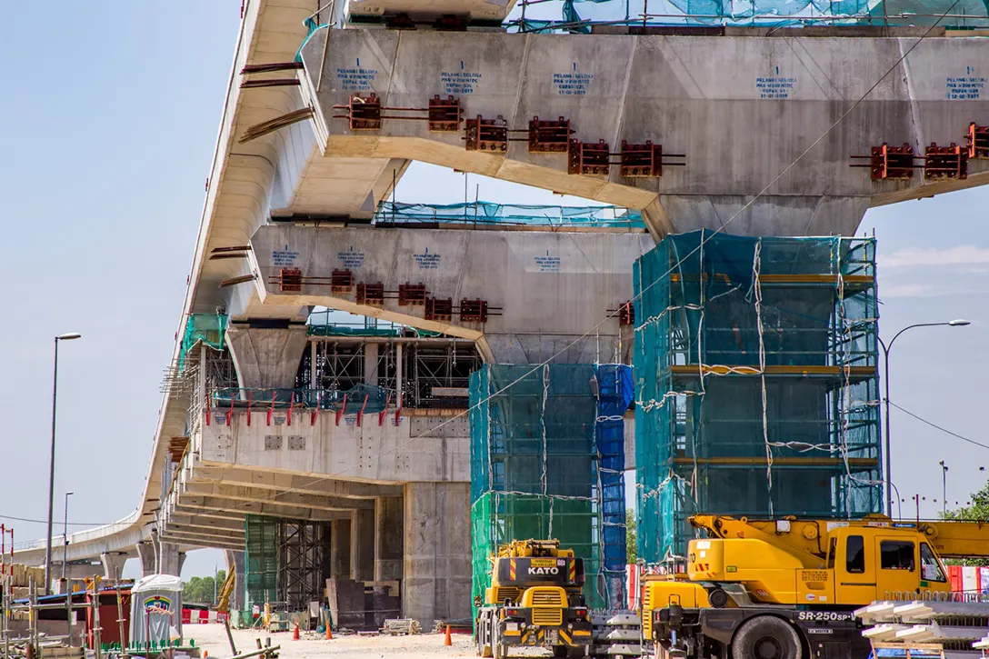 Final stressing for precast T-beam crossing in progress at the Putra Permai MRT Station.