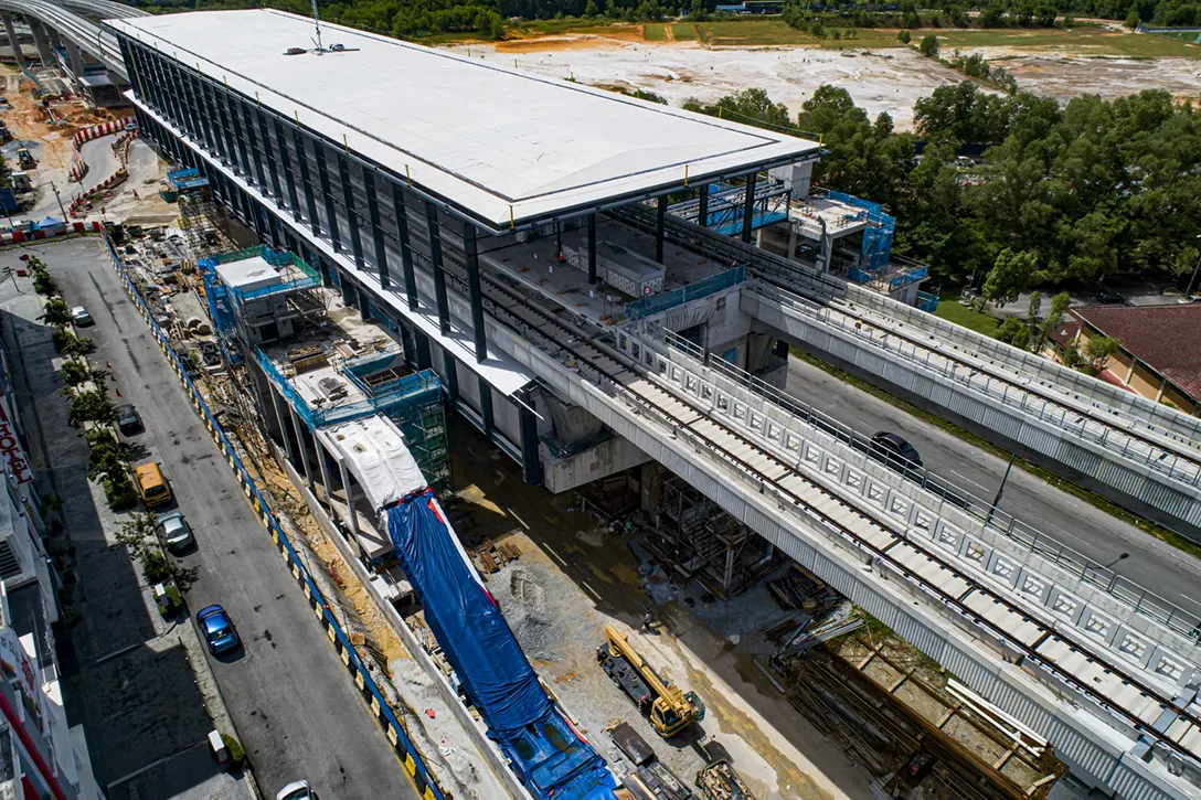 Aerial view of the Putra Permai MRT Station showing the architectural works in progress at platform and concourse levels.