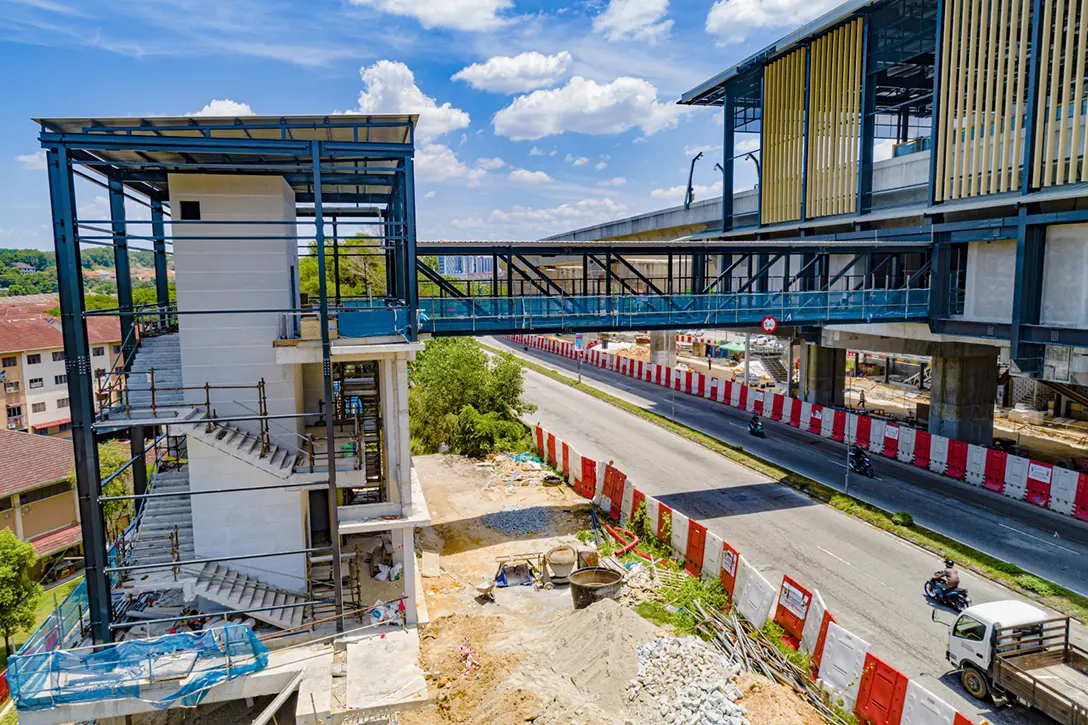 Aerial view of the Entrance 2 Putra Permai MRT Station showing architectural works such as box fin, mesh and louvres in progress.
