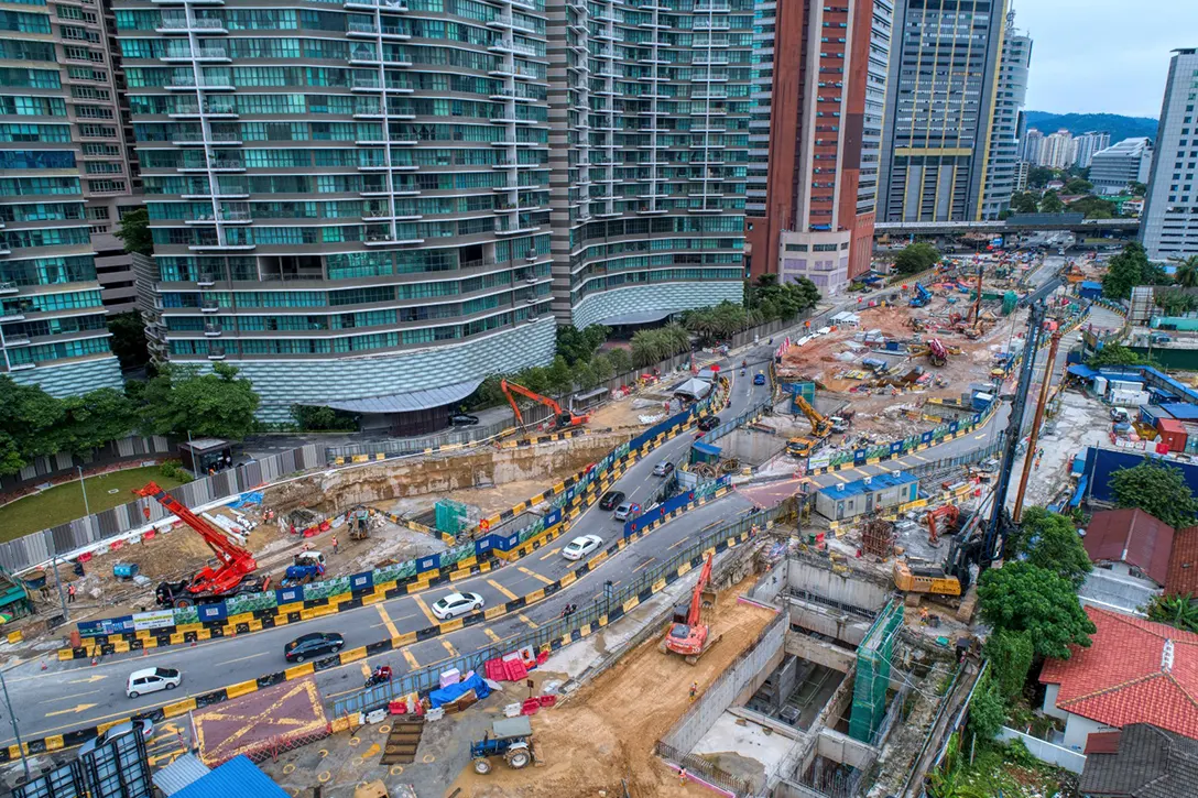 Aerial view of the Raja Uda MRT Station showing backfilling works in progress at Entrance A in preparation for traffic diversion and construction of roof slab in progress at the Entrance B.