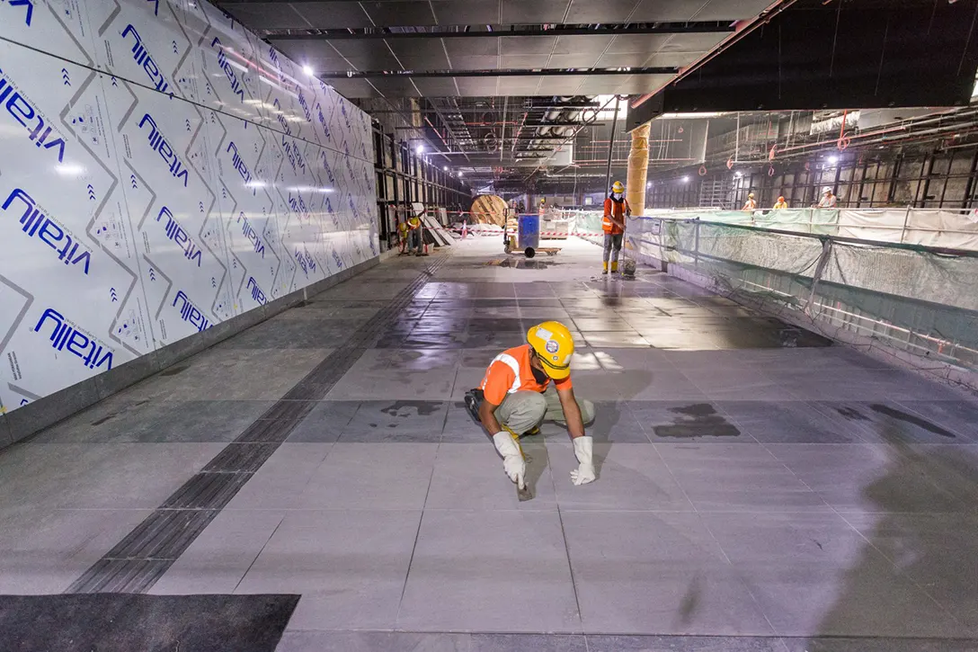 Final touch-up to tiling works for inspection at the Raja Uda MRT Station.