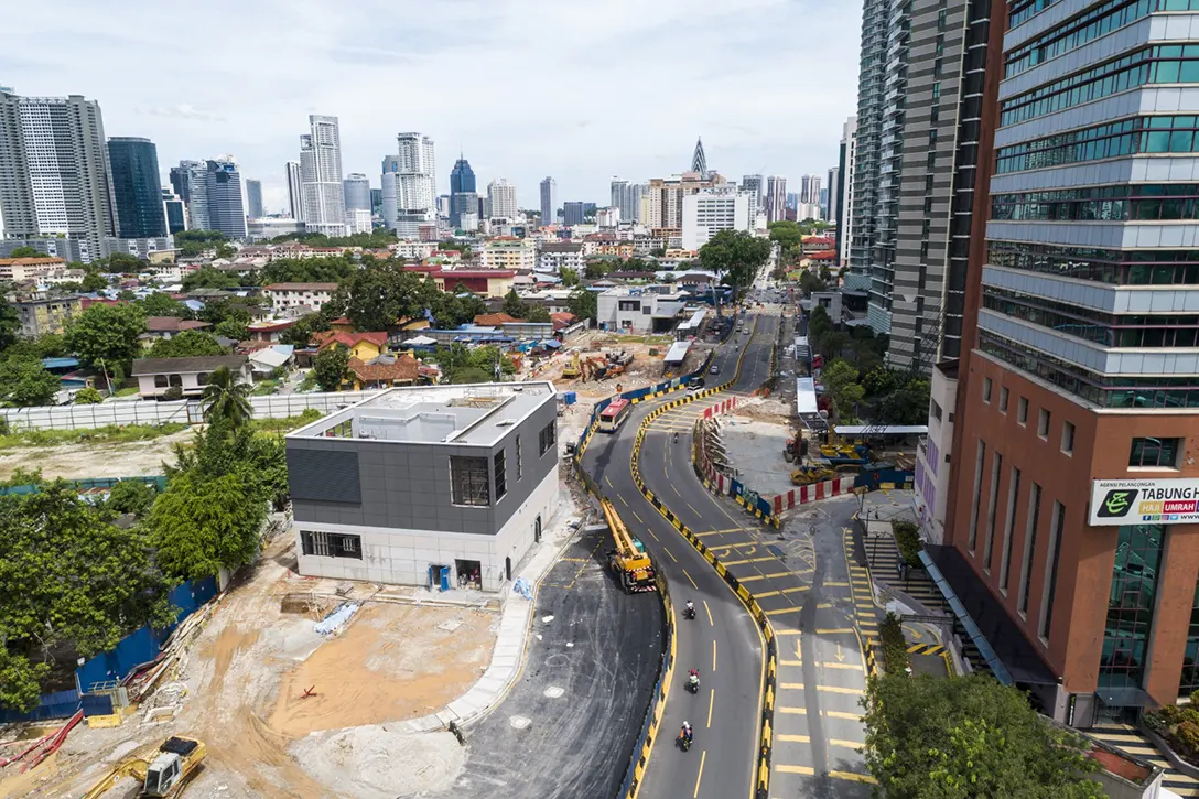Aerial view of the completed structure of Raja Uda MRT Station Ventilation Building B and works in progress to complete the remaining road and drainage works in preparation for DBKL inspection.