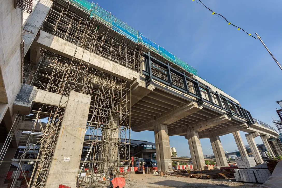 Erection of scaffolding and falsework from ground to platform level at the Sungai Besi MRT Station site.
