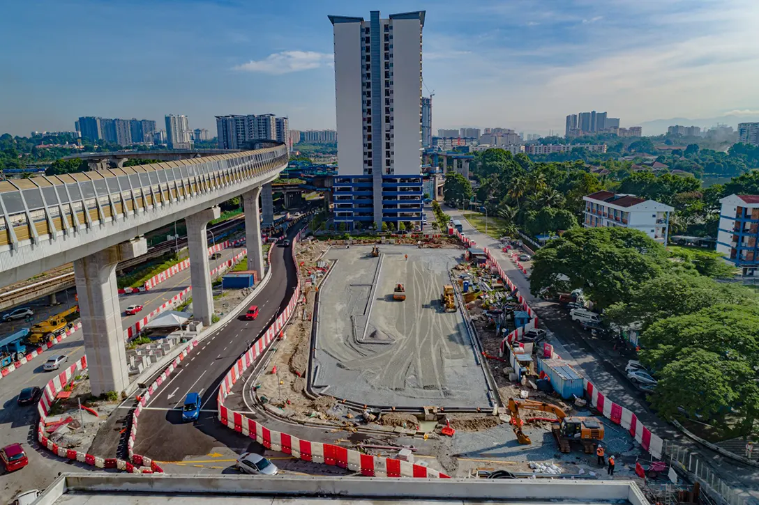 Aerial view of the Sungai Besi MRT Station At-Grade Park and Ride showing the walkway, fencing and compound lighting works in progress.