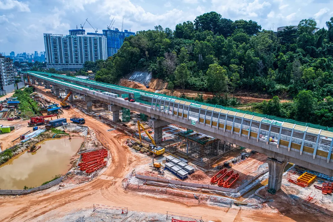 Aerial view of the permanent noise barrier installation and station concourse works in progress at the Taman Naga Emas MRT Station site.