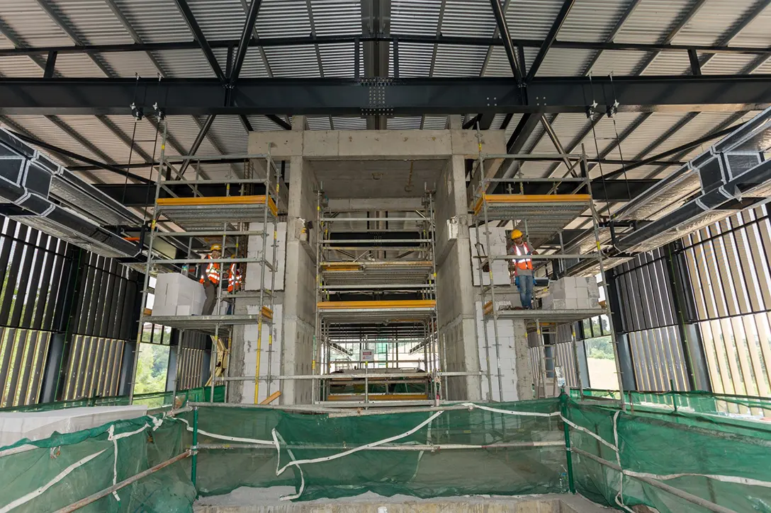 Block wall for architecture finishing for riser next to the lift core in progress at Taman Naga Emas MRT Station platform level.