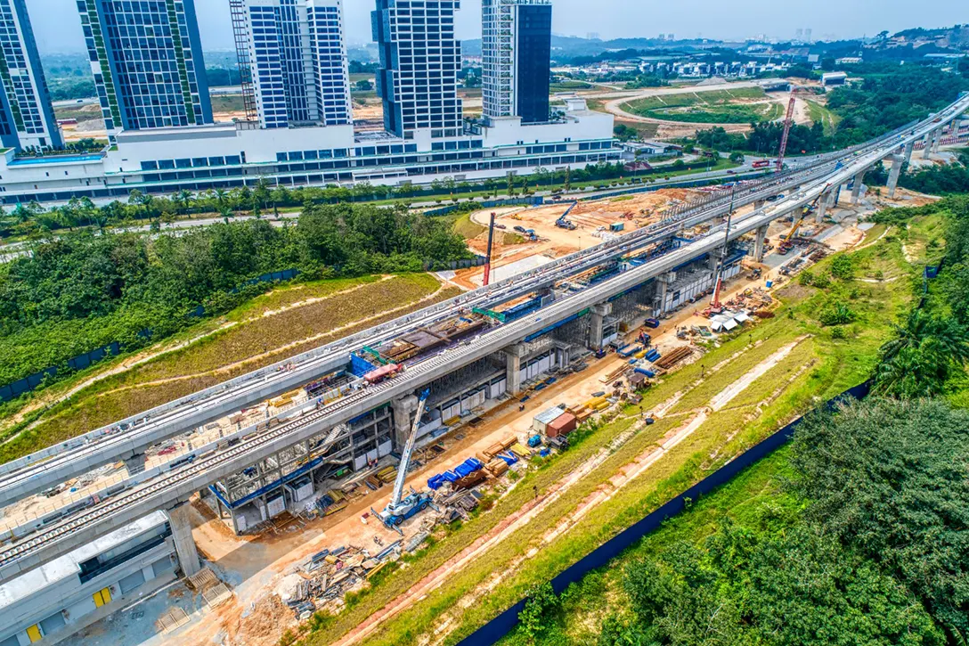 Aerial view of the Cyberjaya Utara MRT Station site showing the station box platform and post-tensioned beam formwork installation in progress.